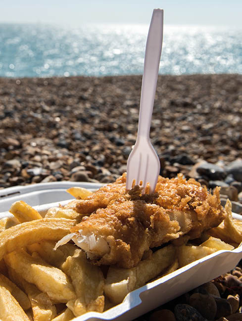 Delicious fish and Chips take away meal enjoyed on the beach